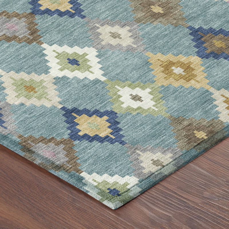 Teal blue area rug corner with multicolor geometric pattern on wood floor