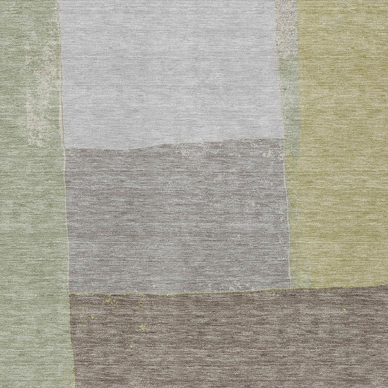 Top view close-up of geometric wash area rug with off-white and green square blocks