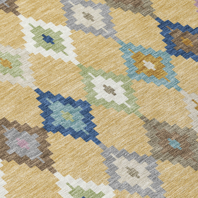 Aztec area rug close-up, gold ground with teal blue and gray diamond pattern