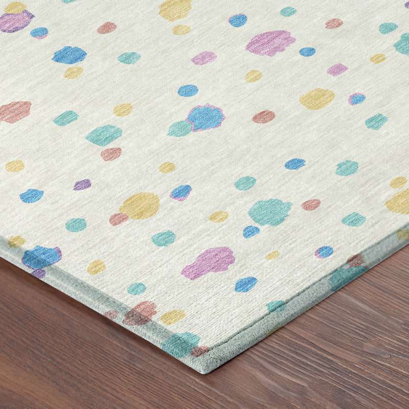 Ivory geometric area rug with colorful speckled shapes; corner and border detail shown