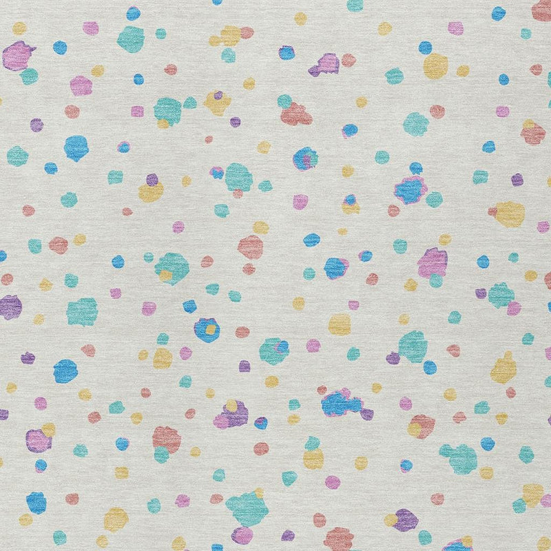 Ivory area rug featuring scattered geometric dots and blocks in teal, blue, purple, yellow