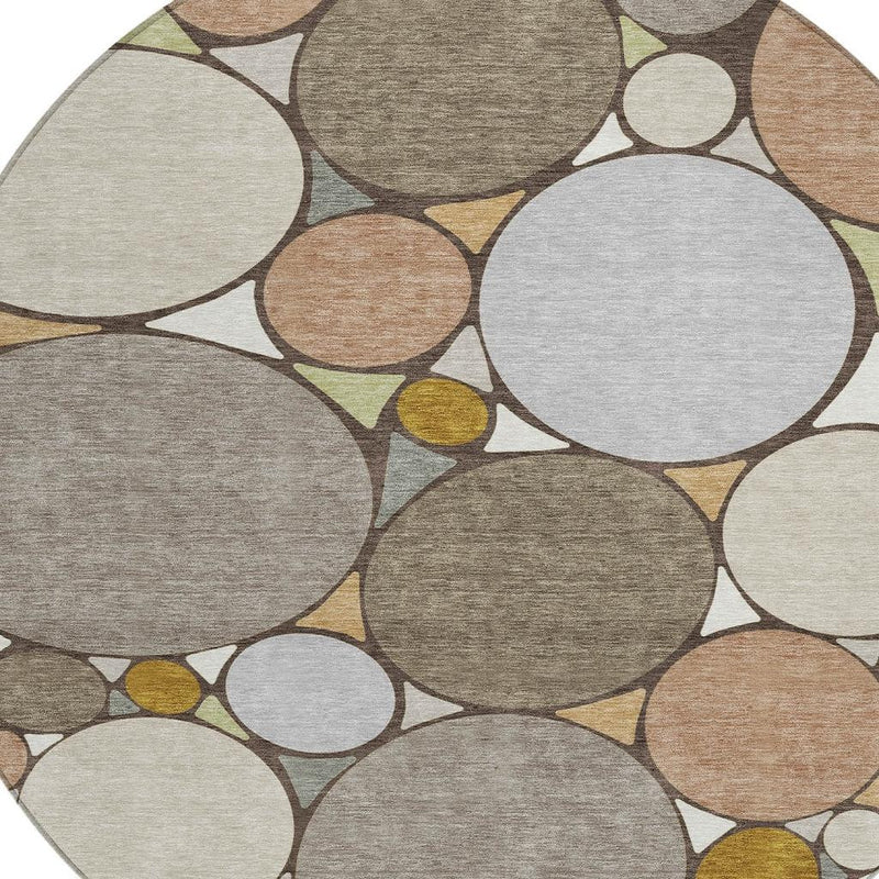 Round geometric rug pattern of overlapping circles in gray, tan, beige, and gold accents