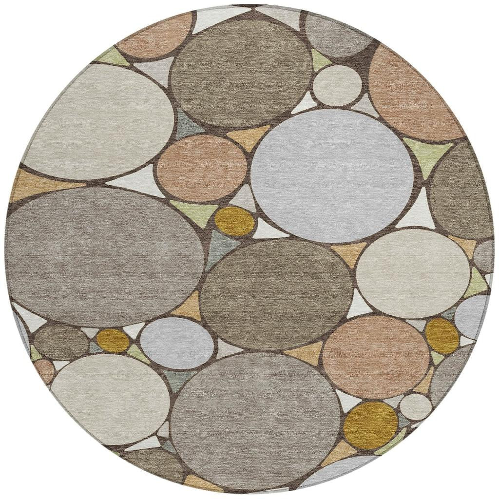 Round geometric area rug featuring overlapping circles in gray, beige, taupe, and light gold