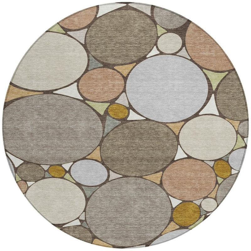 Round geometric area rug featuring overlapping circles in gray, beige, taupe, and light gold