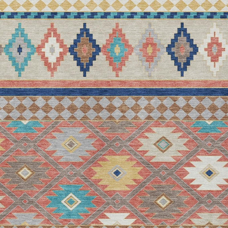 Close-up southwestern rug with beige base and coral, blue, and teal diamond patterns.