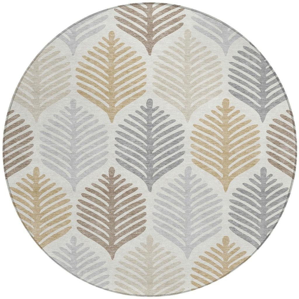 Round area rug with repeating leaf silhouettes in gray, beige, and ivory