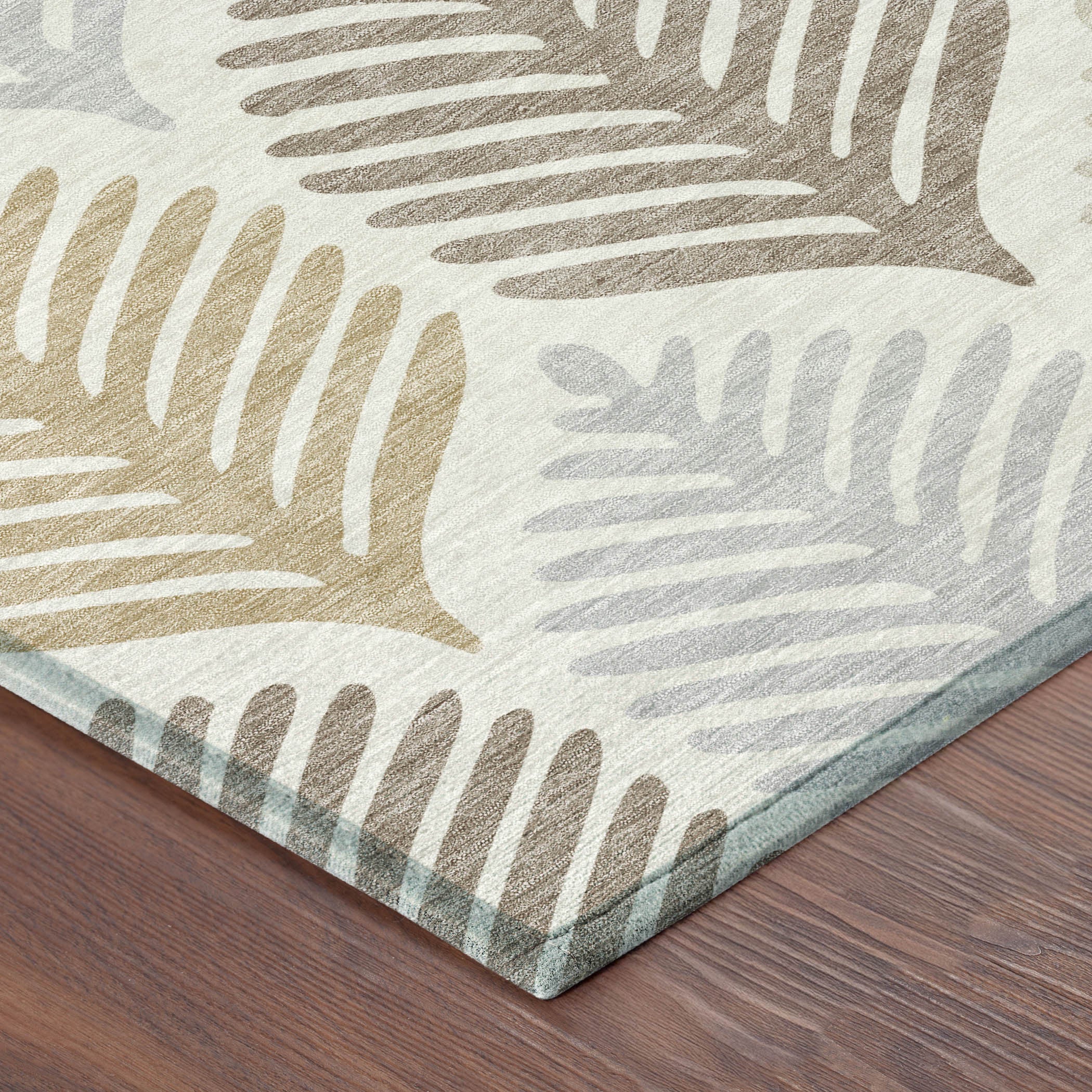 Ivory round area rug with layered leaf pattern in beige, tan, and gray