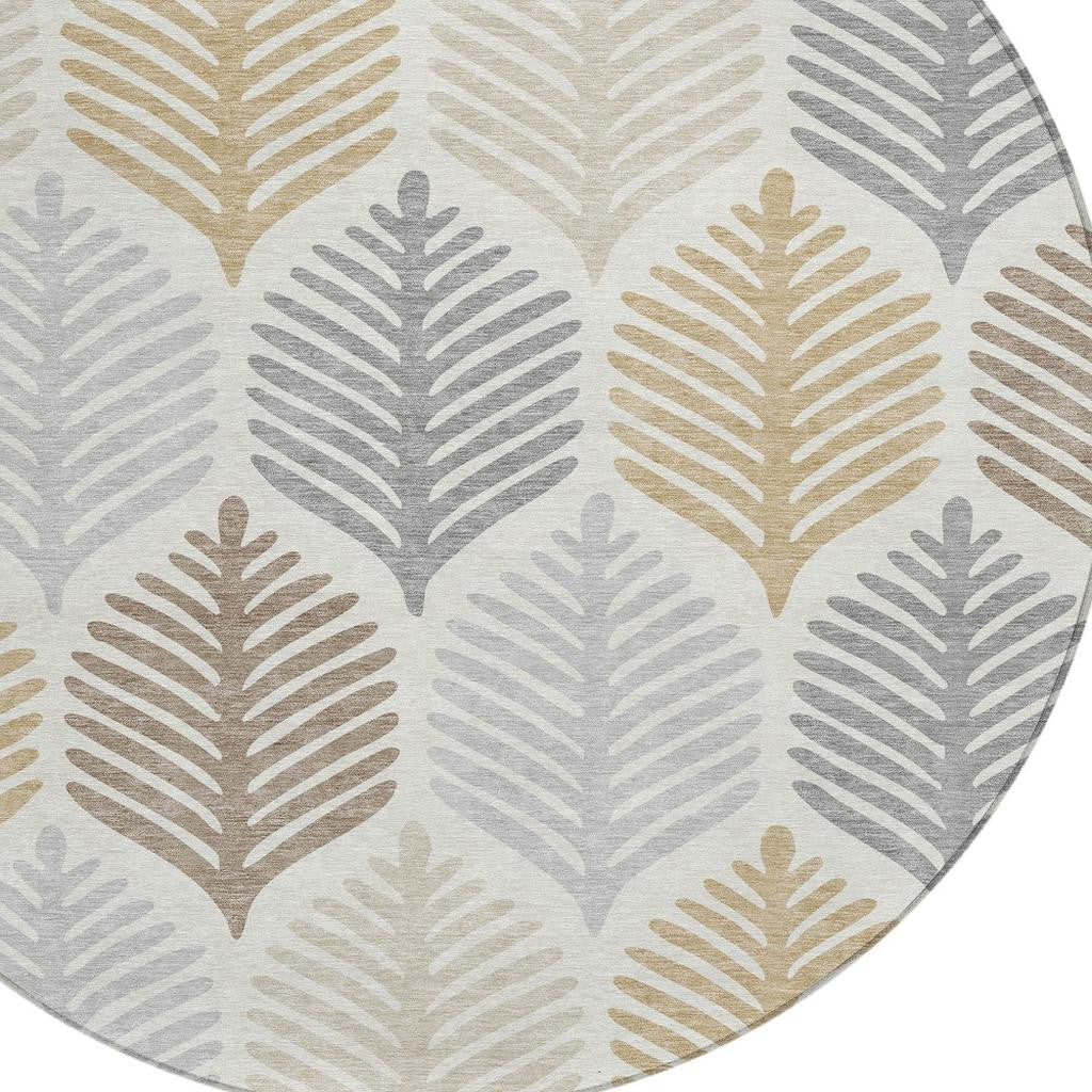 Ivory round rug close-up with leaf silhouettes in gray and beige