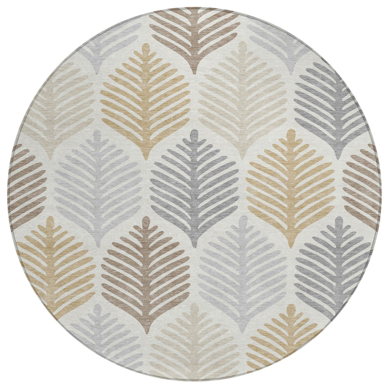 Round area rug with scattered leaf prints in light gray, tan, and ivory