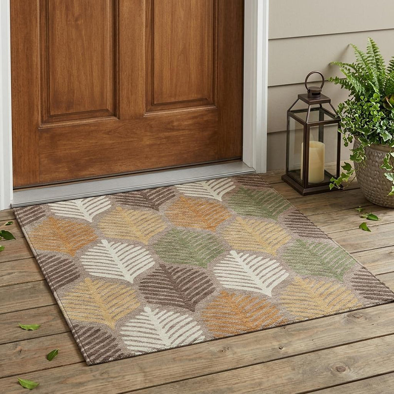 Indoor/outdoor area rug on wood floor with taupe base and multicolor leaf pattern
