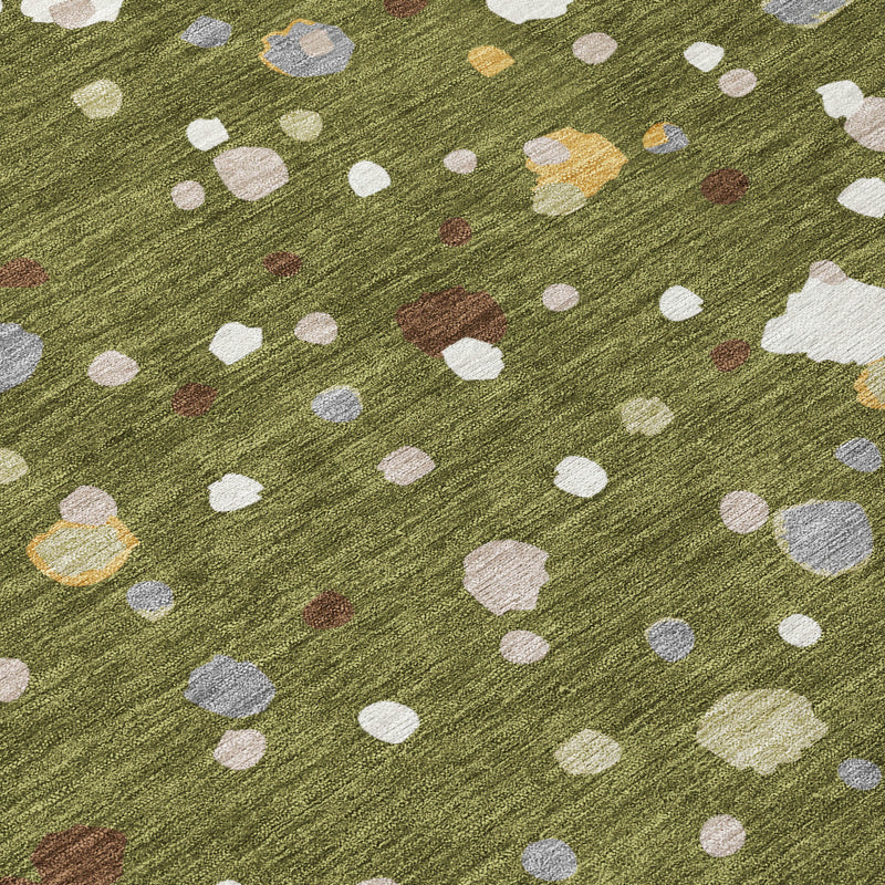 Olive green rug with white, gray, and small tan accents in dot pattern