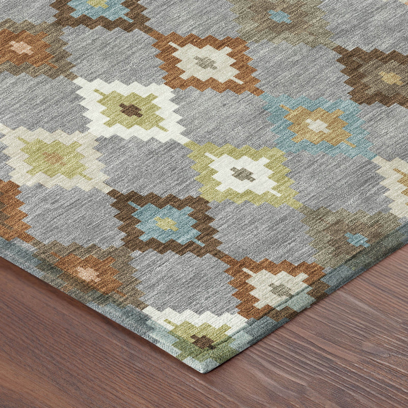 Gray area rug with orange, blue, green, and cream geometric diamond pattern closeup