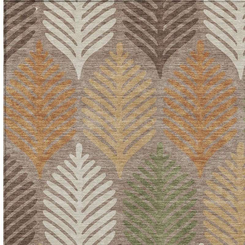 Pattern detail on taupe area rug with beige, yellow, orange, and green leaf outlines