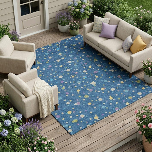 Indoor outdoor area rug with navy blue background and scattered multicolor geometric dots