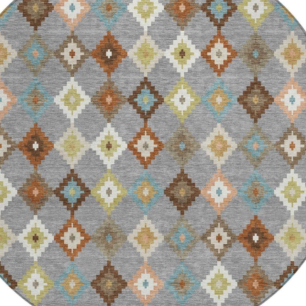 Round rug with light grey base and multicolor geometric diamond Aztec pattern.