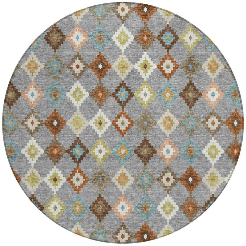 Round indoor outdoor rug with grey background and multicolor diamond Aztec pattern.