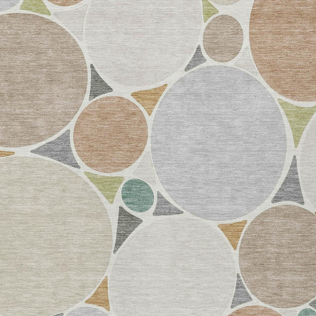 Geometric area rug with large white, beige, and gray circle motifs and soft green details