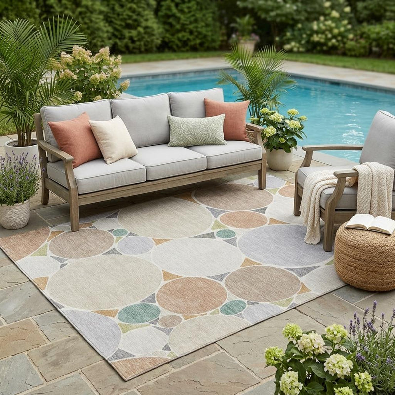Outdoor-ready area rug with beige, gray, and muted green circular geometric pattern