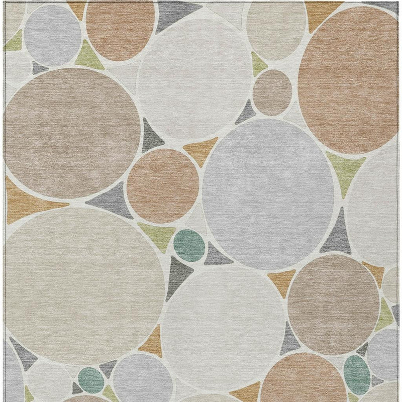 Beige and gray geometric area rug with circular pattern and muted green accents, flat lay