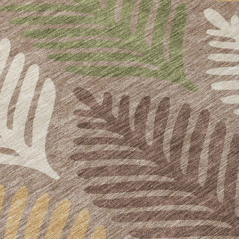 Round indoor/outdoor area rug close-up: taupe and multicolor leaf print on neutral base
