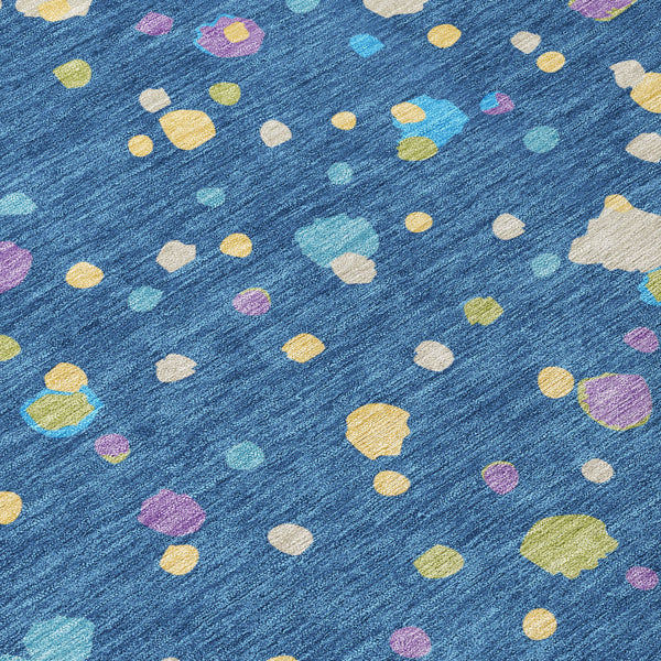 Navy blue geometric area rug with multicolor speckled shapes, short pile texture