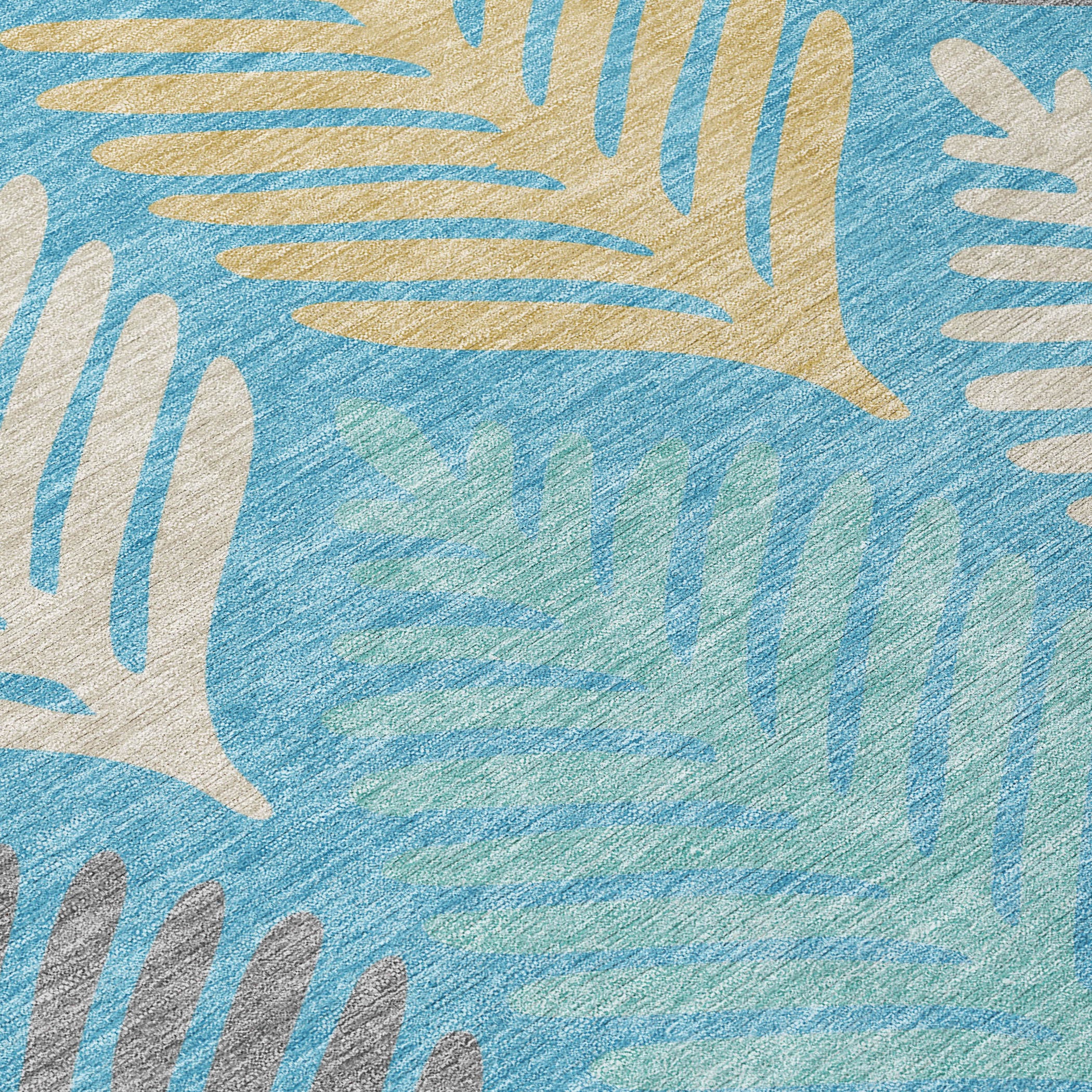 Teal blue area rug with ivory and gold leaf-like motifs, close-up.