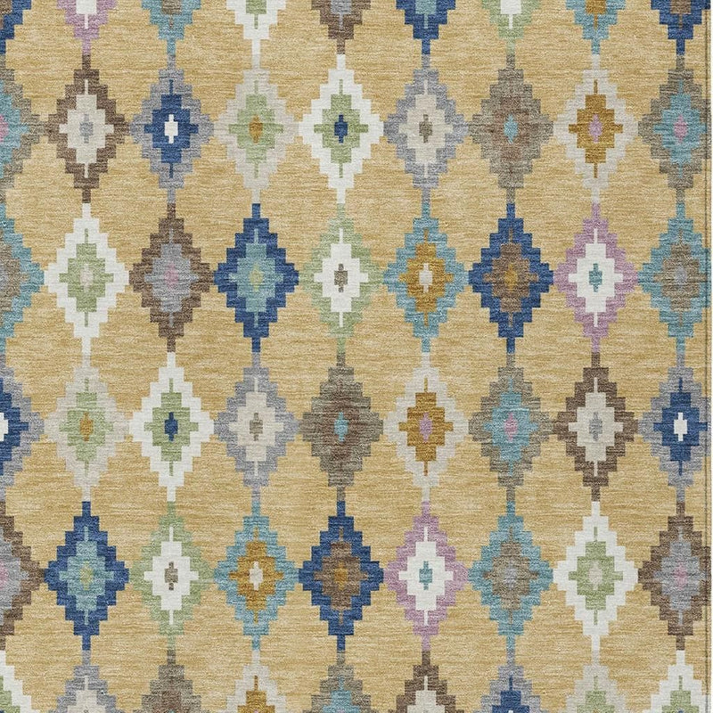 Tight close-up of indoor outdoor area rug with multicolor Aztec diamonds on gold background
