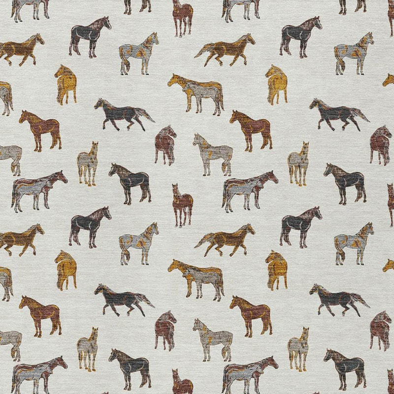 Ivory area rug close-up with scattered brown, black, and gold horse prints