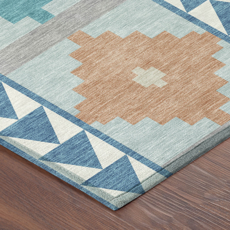 Teal, blue, gray, and ivory southwestern area rug corner with zigzag border and diamond motifs
