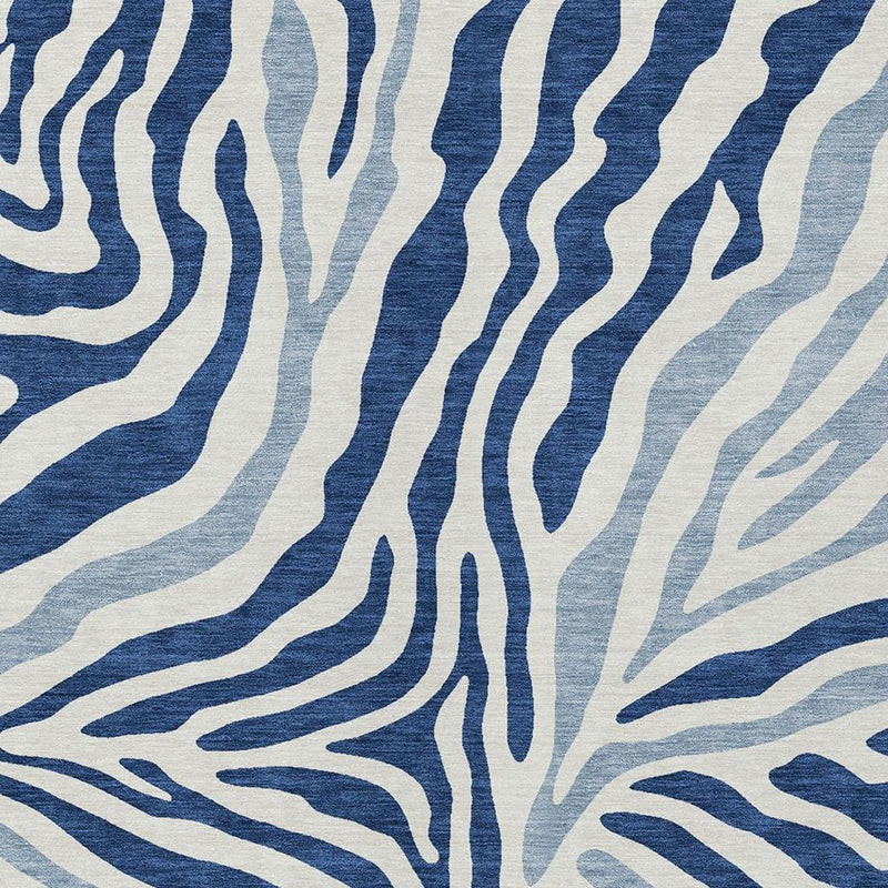 Close-up of navy and ivory zebra-style wavy lines on light blue rug background