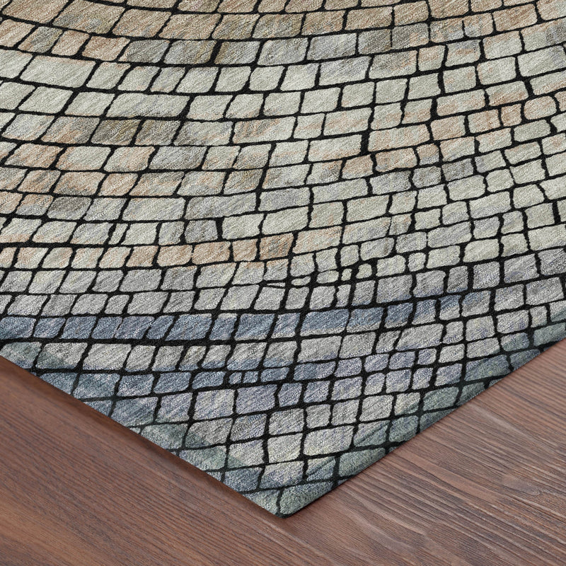 Corner of round geometric rug showing brick-texture pattern in beige and dark gray