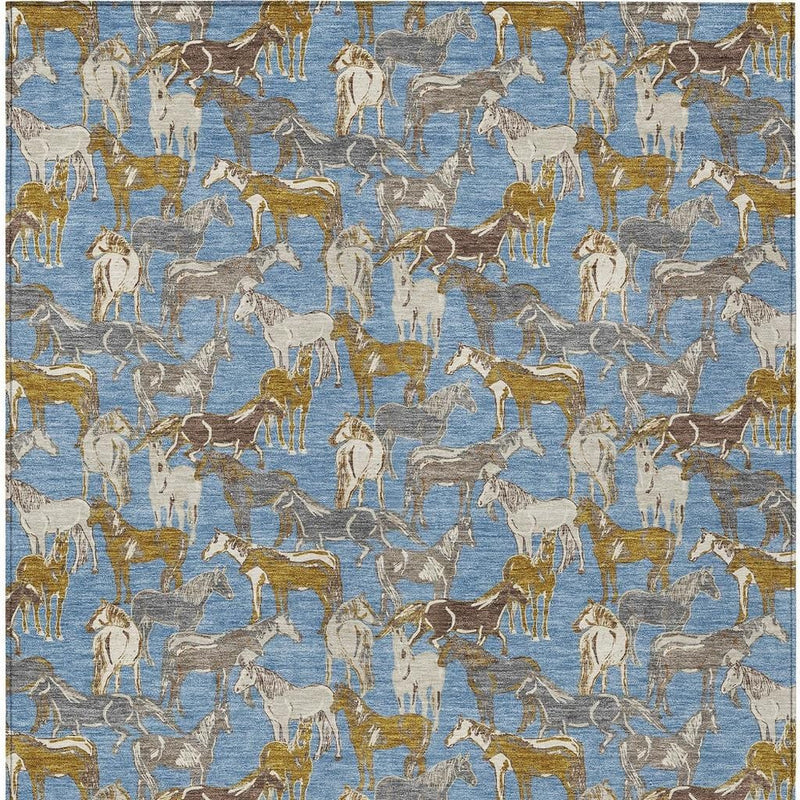 Indoor outdoor area rug with repeating horse silhouettes in blue, beige, and gold