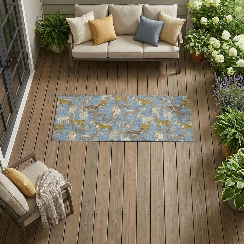 Rectangular indoor outdoor area rug featuring blue and beige horse print on wood floor