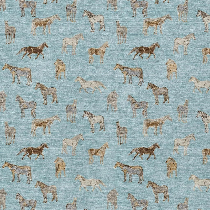 Close-up of blue rug with beige and tan horse silhouettes repeating pattern.