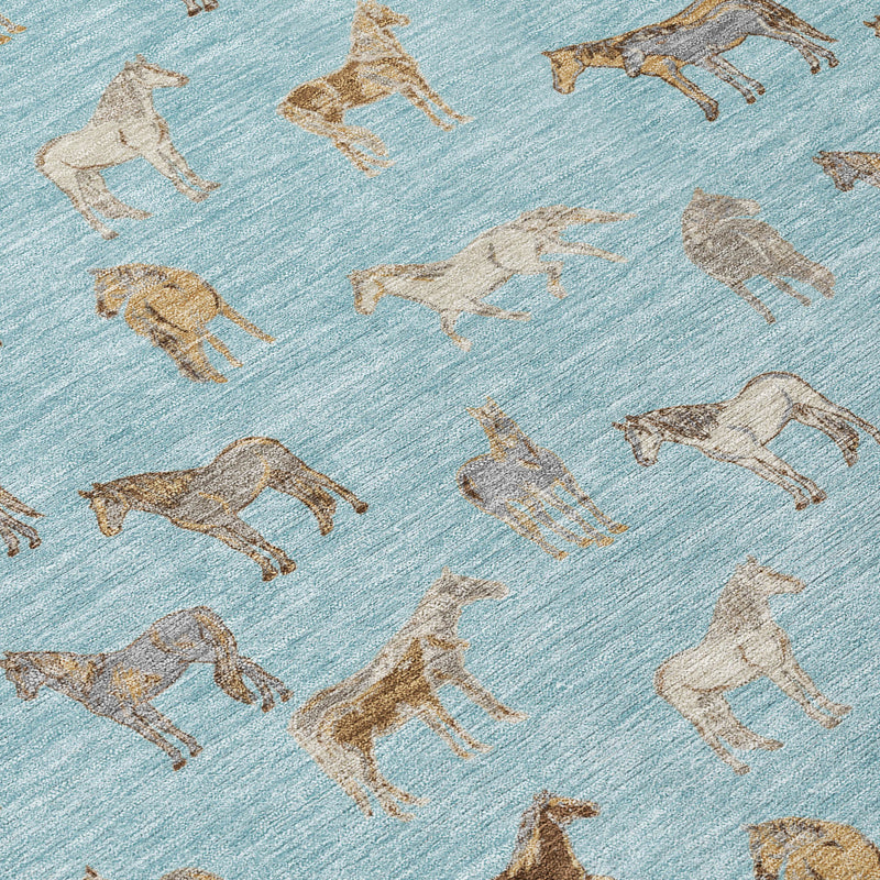 Blue area rug corner detail with beige and tan horse silhouettes pattern.