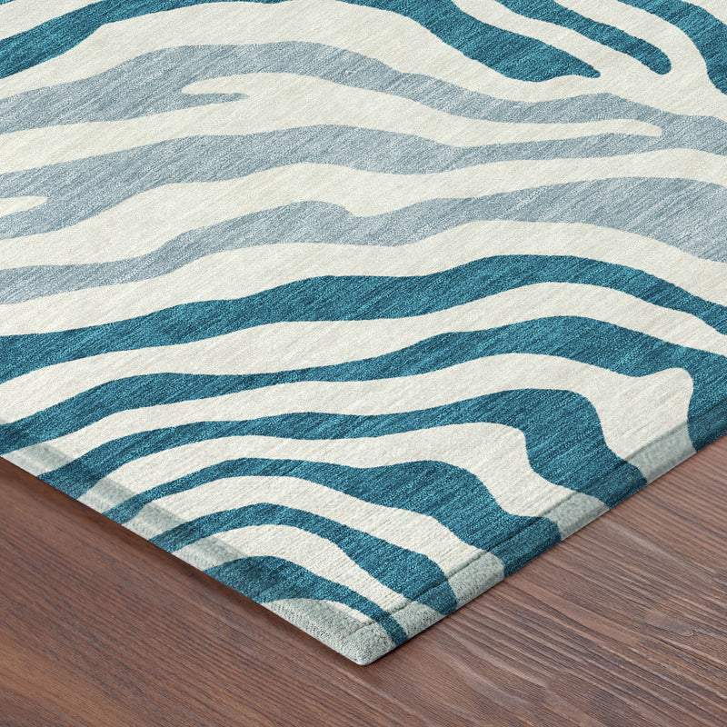 Corner detail of teal blue and ivory zebra stripe indoor outdoor washable area rug