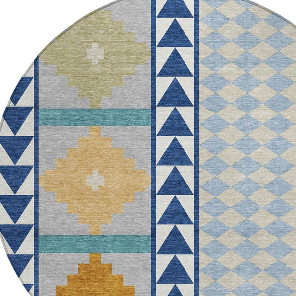 Round southwestern area rug with navy, sky blue, tan, and green geometric panels