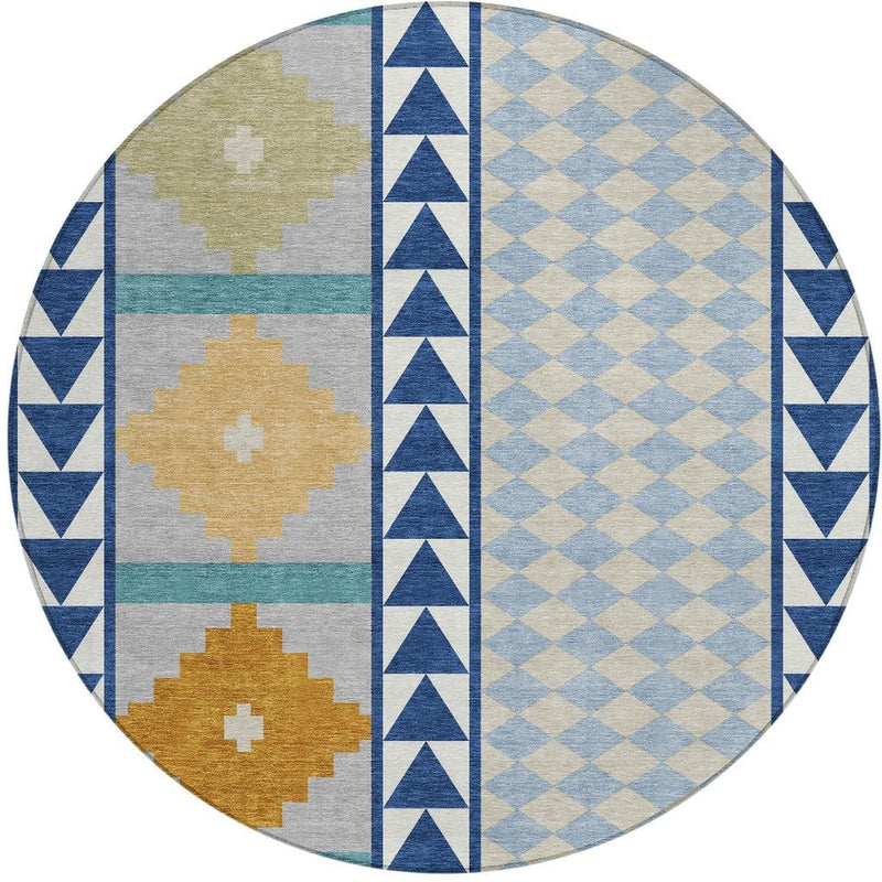 Round geometric area rug featuring blue diamond blocks, navy stripes, and tan crosses