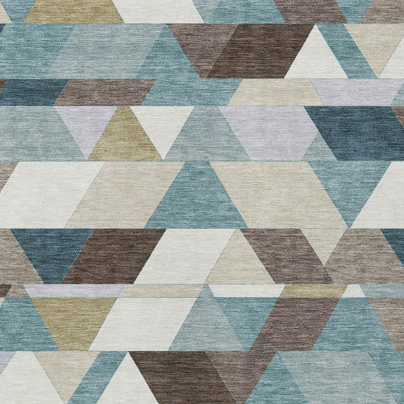 Geometric area rug texture with overlapping triangles in teal, aqua, brown, and cream