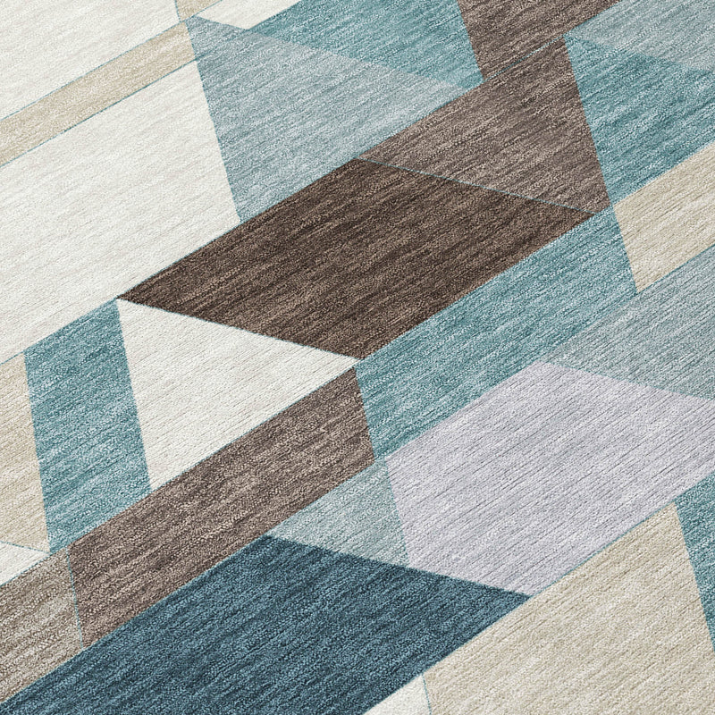 Textured rug detail featuring teal blue and pale aqua triangle blocks with brown accents