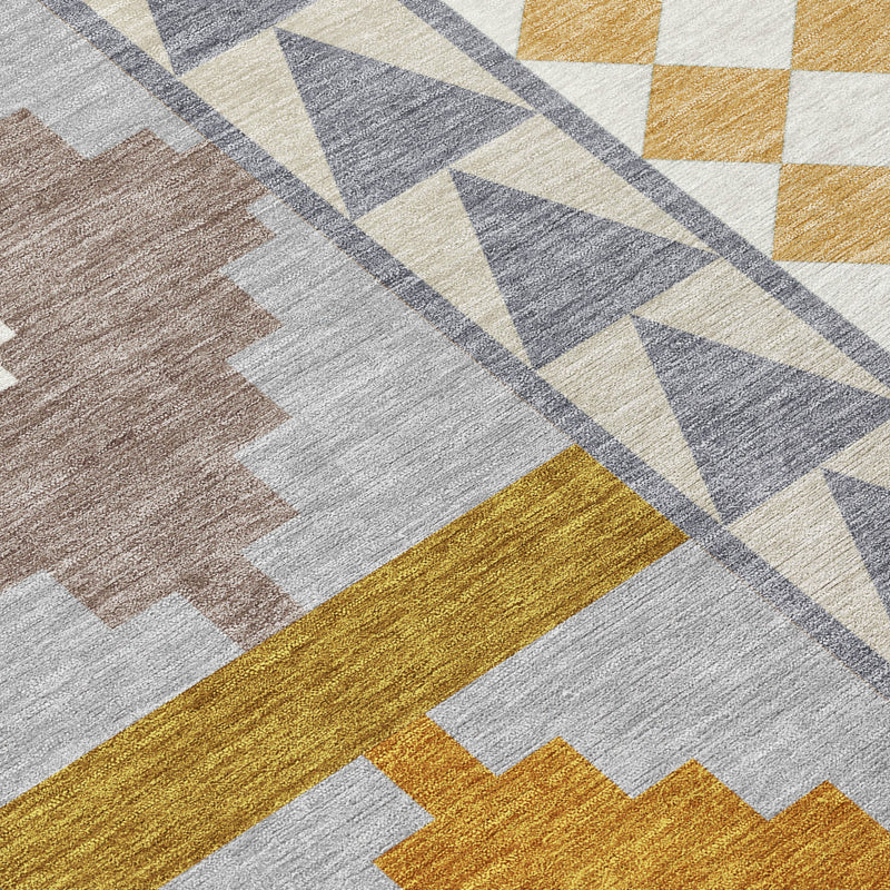 Close-up of gray, beige, and mustard geometric lines and striped sections on rug