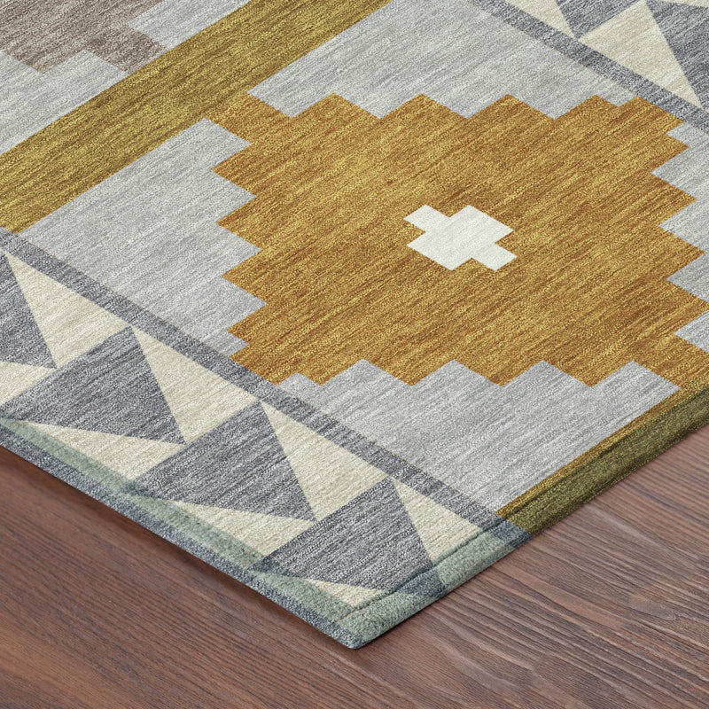 Corner detail of round area rug with mustard diamond medallion and gray patterned border