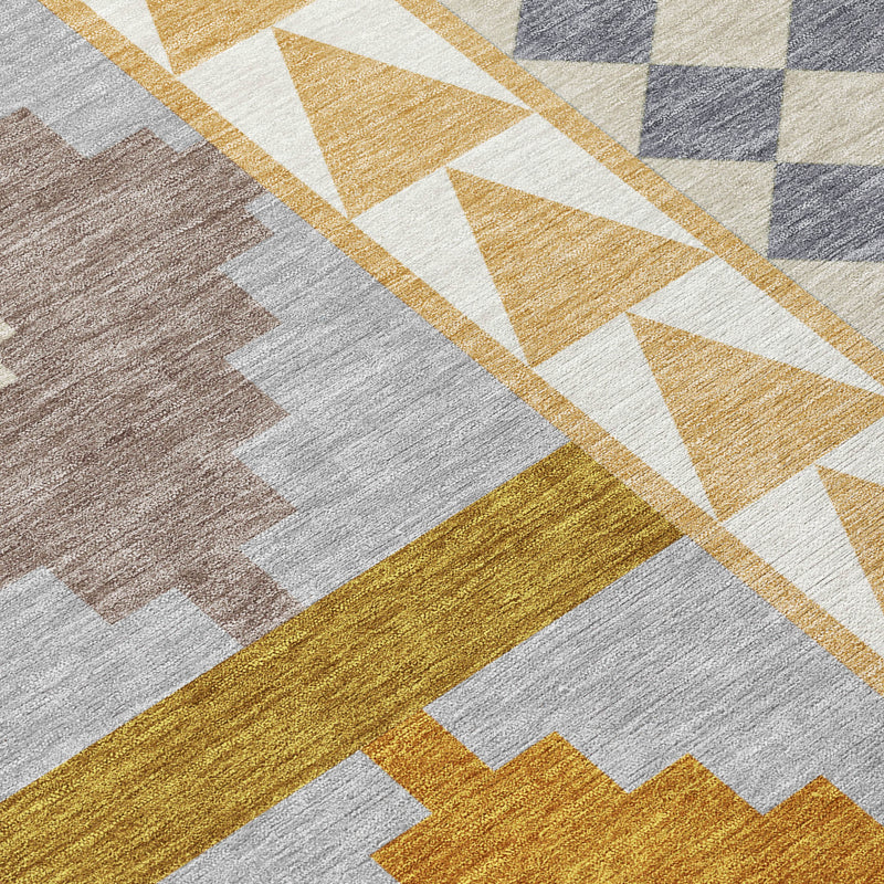 Geometric area rug close-up with chevrons, diamonds and plus motifs in gray, gold and beige