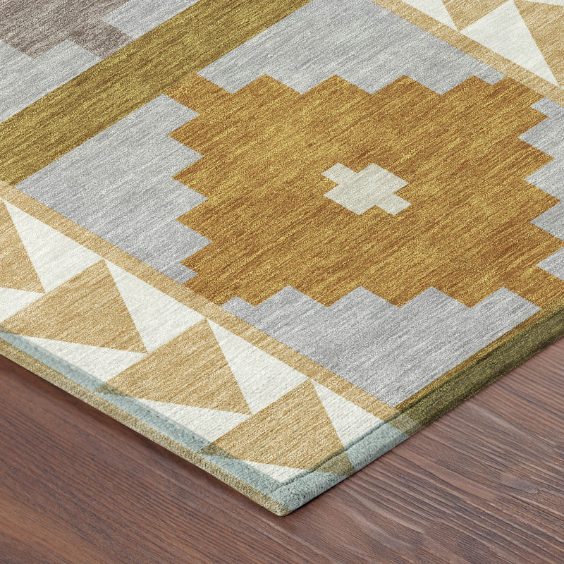Geometric area rug close-up in gray, gold, tan and white with zigzag and chevron lines