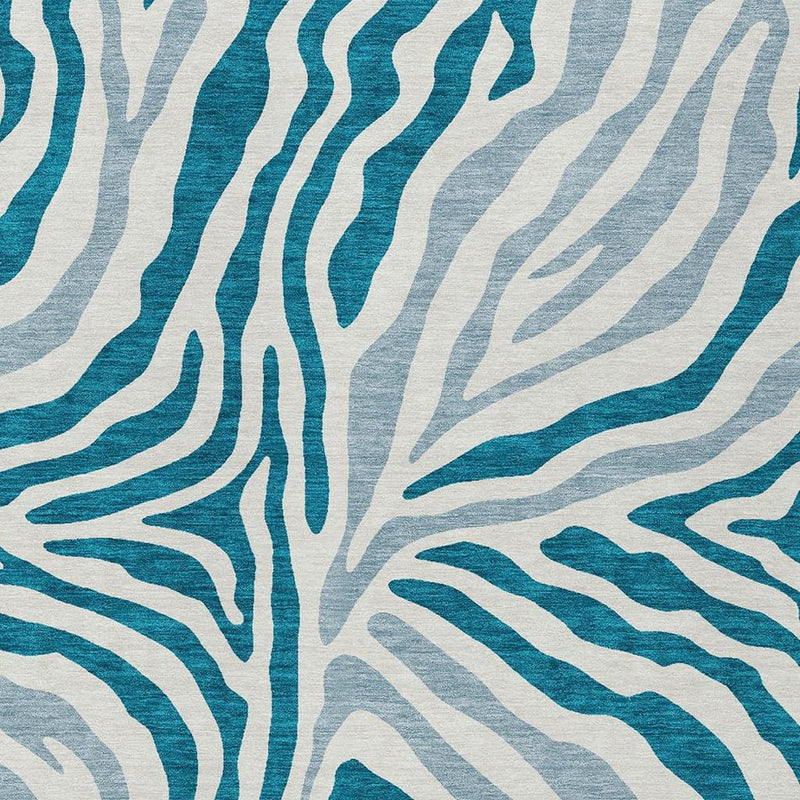 Close-up teal blue and ivory zebra print on an area rug surface