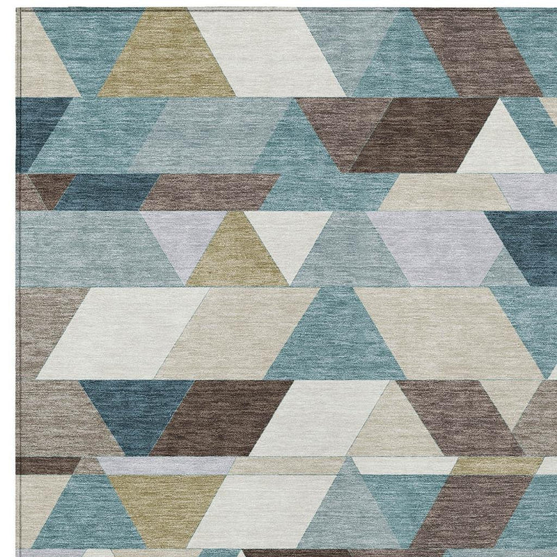 Geometric area rug with teal, pale aqua, brown, and cream overlapping triangle blocks