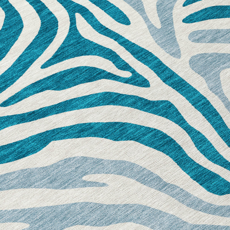 Teal blue and ivory zebra print area rug close-up with repeating lines