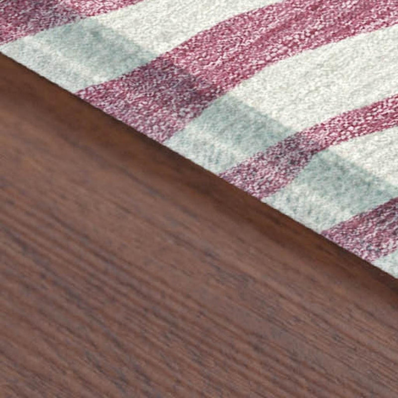 Pink and ivory zebra print area rug corner detail with textured stripe border