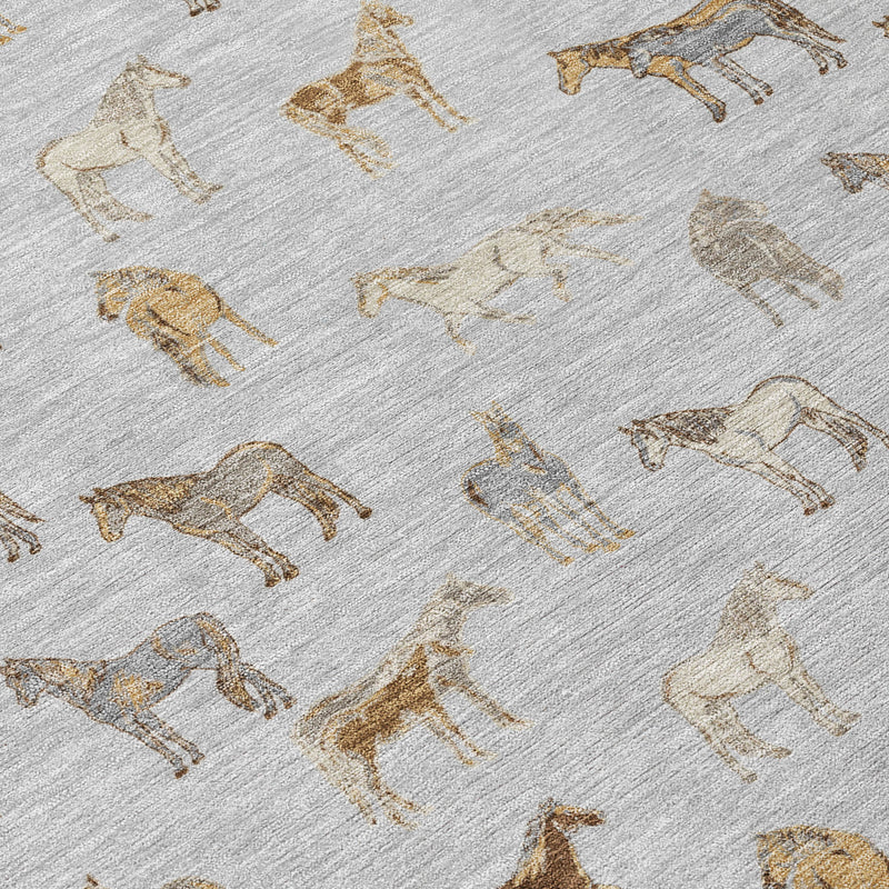 Close view of light gray rug with tan and gold horse silhouettes, woven texture