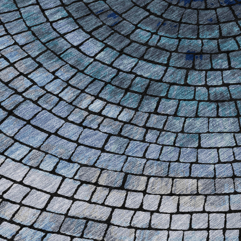 Denim blue geometric rug close-up with curved brick grid and faded light accents